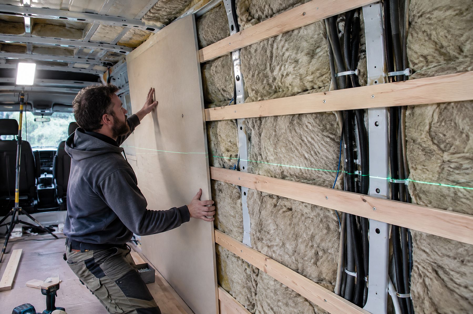 Fitting a wall panel over insulation and wiring
