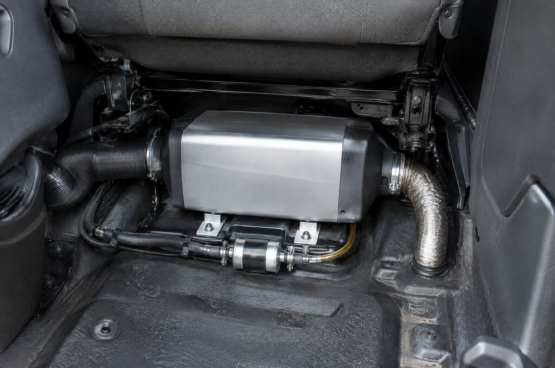 Diesel air heater mounted under the passenger seat