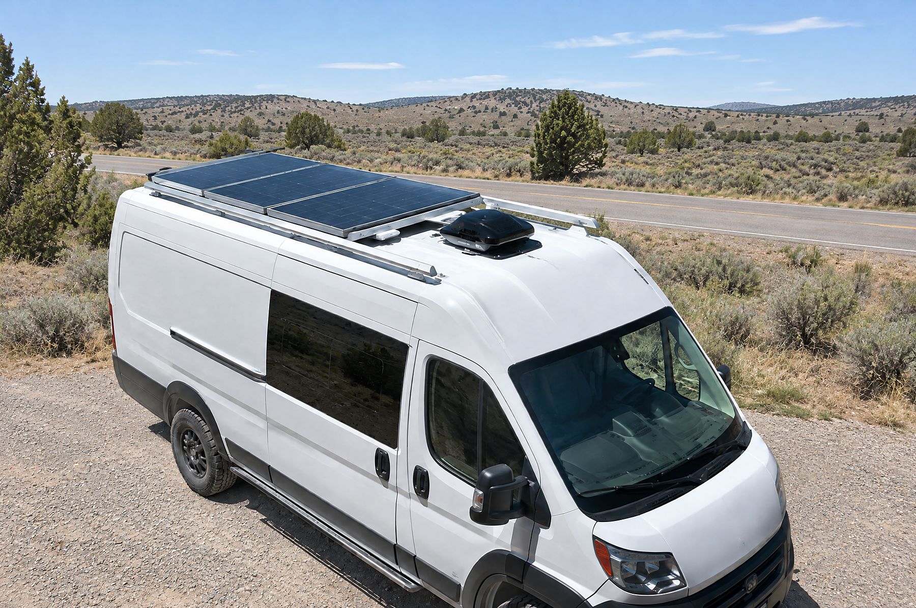 Rigid solar panels and a roof fan on a low-profile roof rack