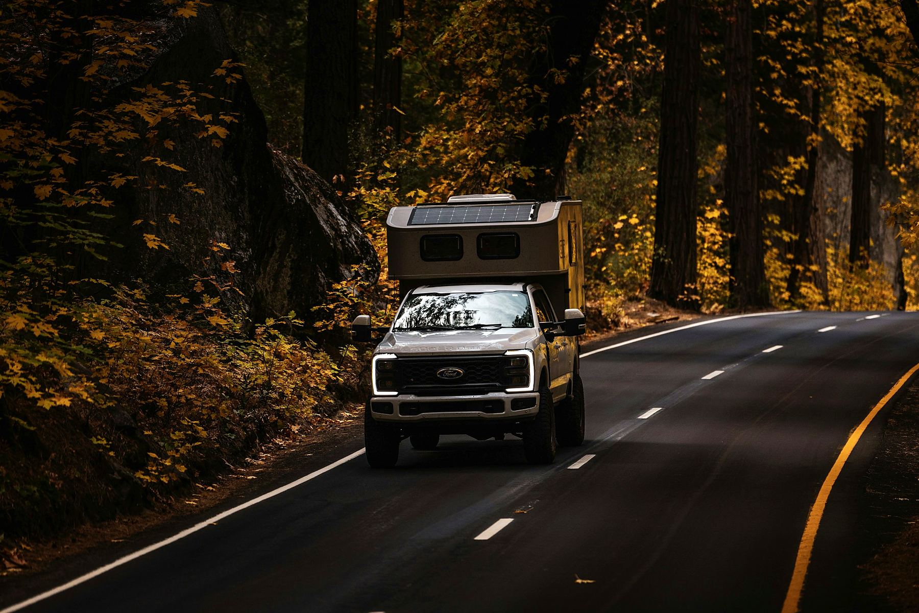 Truck with a pop-up camper (stock photo)