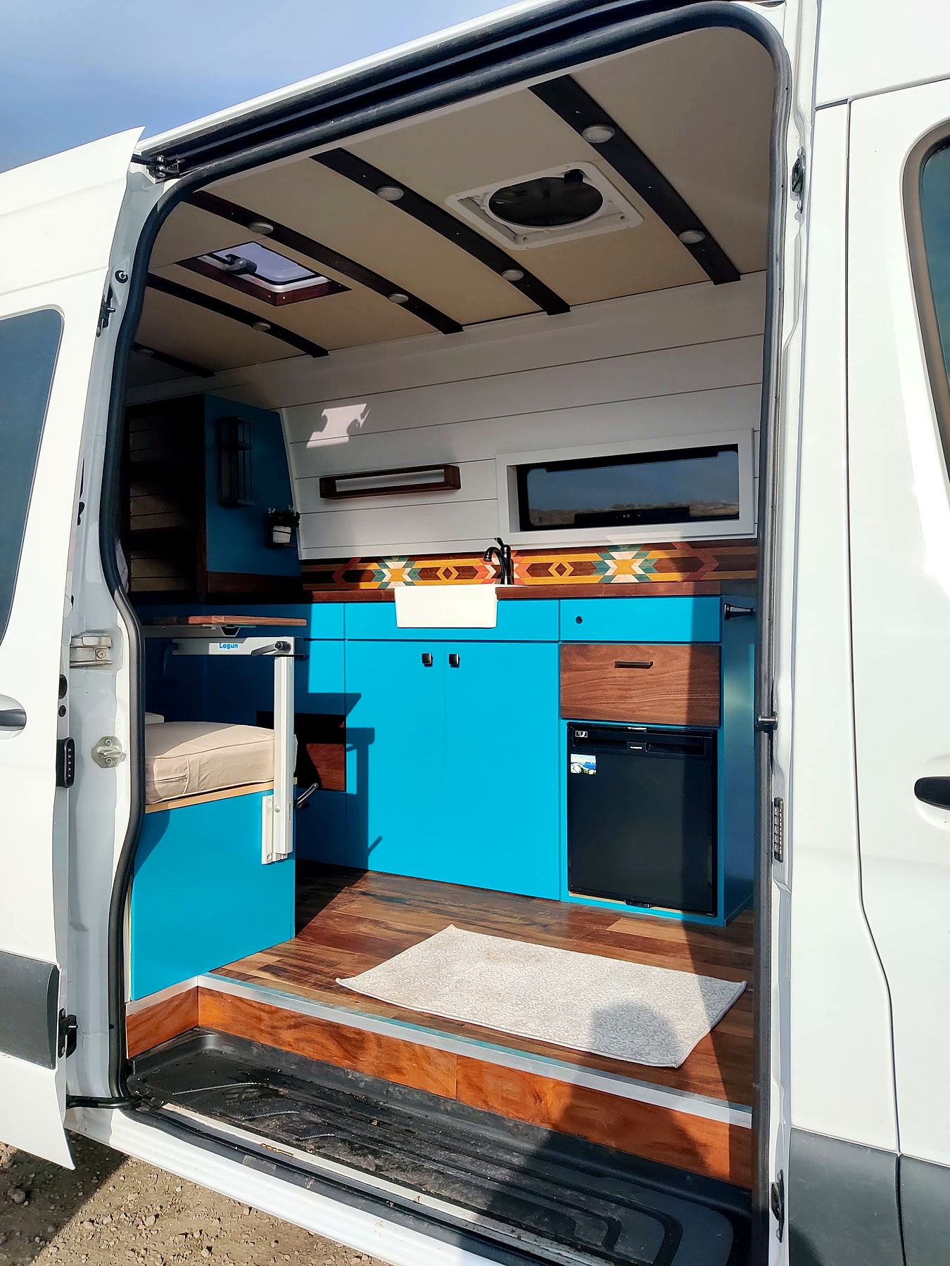 Teal cabinets through the side door